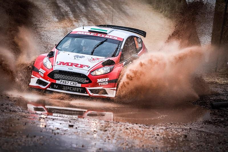 The MRF Tyres M-Sport Fiesta R5 travels through the water splash on SS1 in WRC Rally Italia Sardegna 